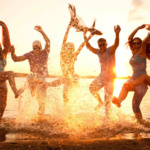 Large group of young people enjoying a beach party